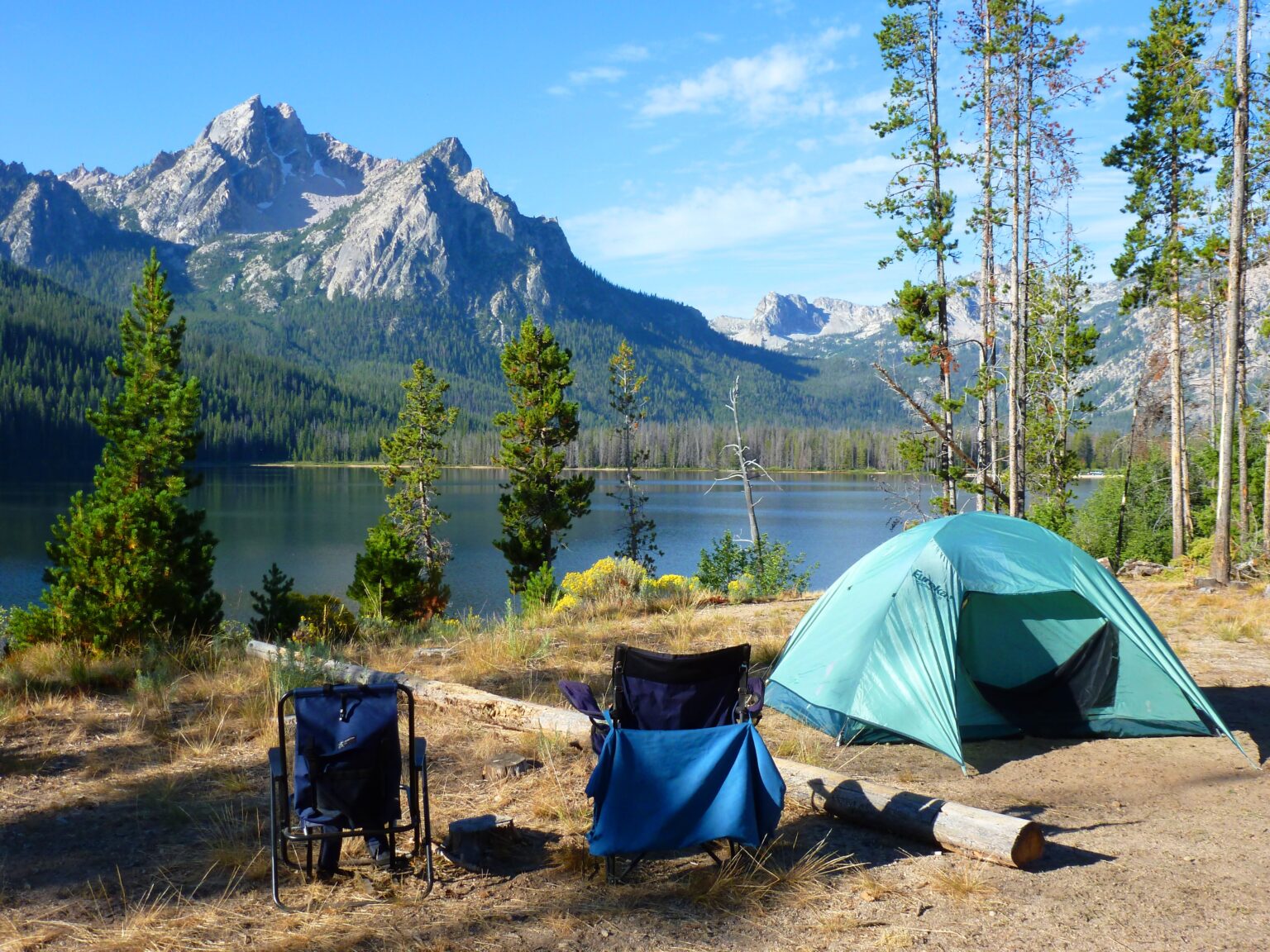 camping tent on the shore of a mountain lake