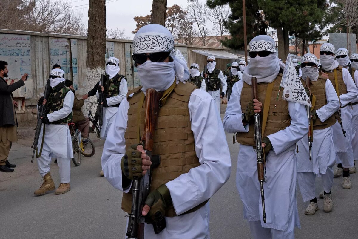 Taliban with masks on their faces and weapons