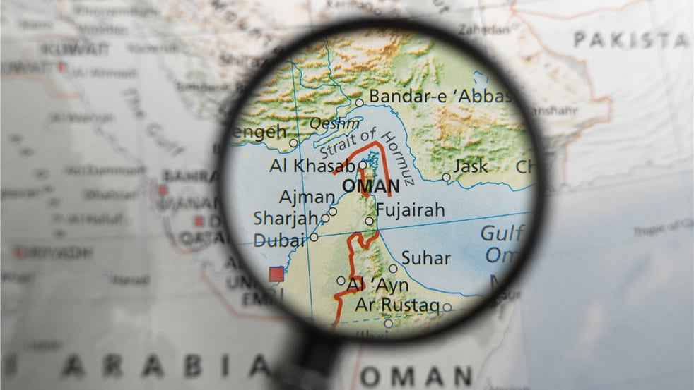 map-of-strait-of-hormuz-and-surrounding-area-under-magnifying-glass-illustration