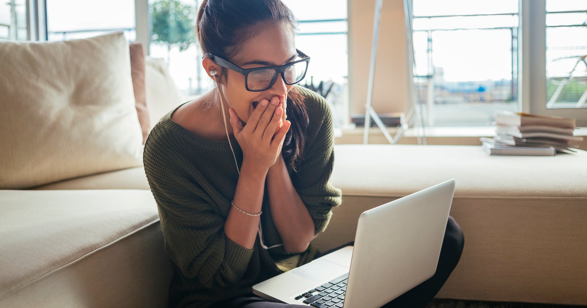 woman reading news on her laptop